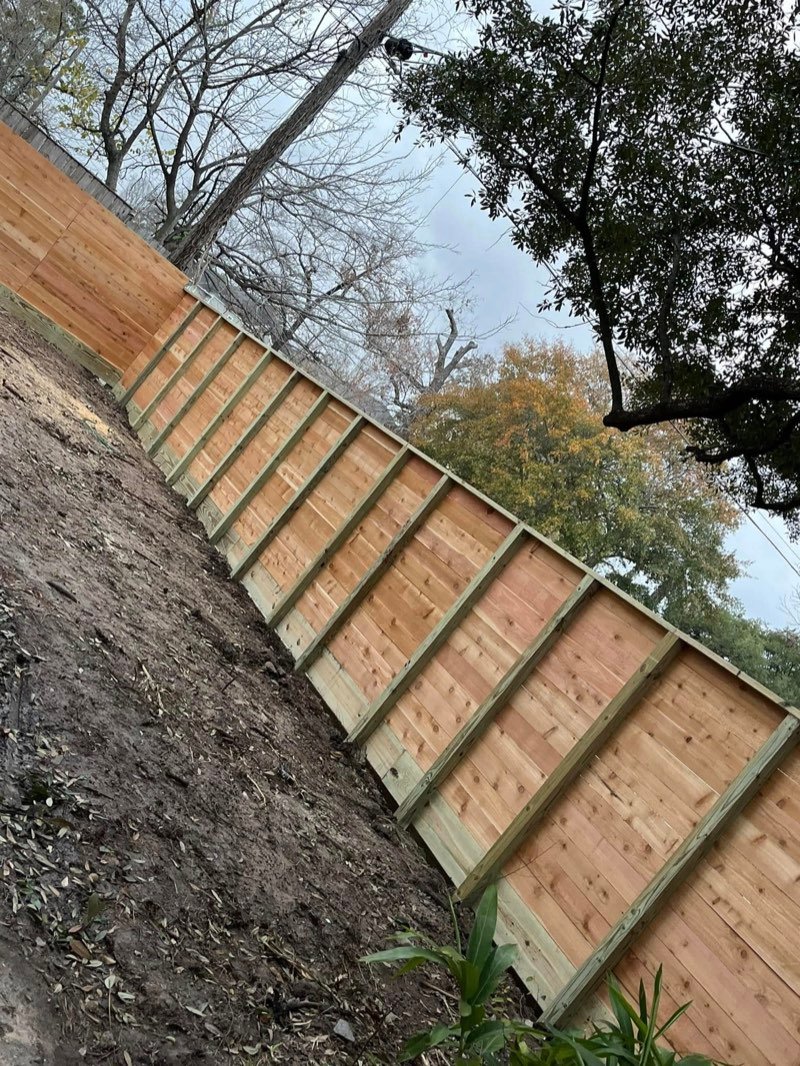 Cedar fence installed on a sloped hillside lot