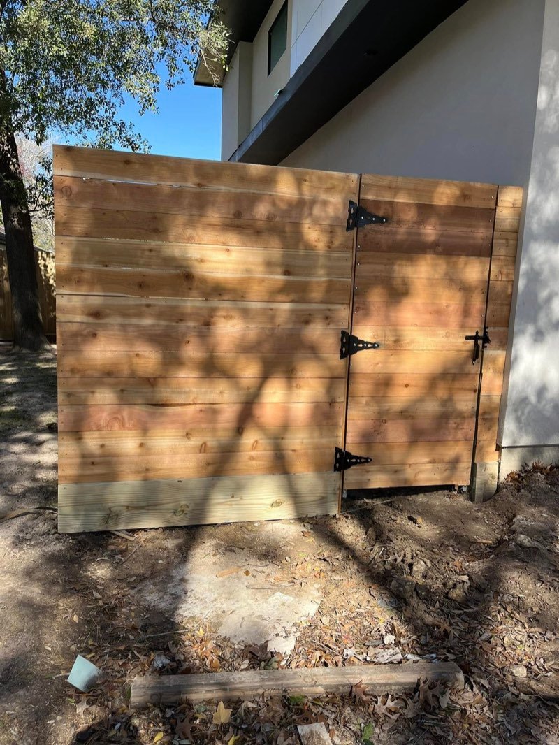 Cedar gate installation beside a home
